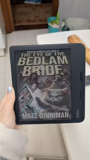 An ereader with the cover of "the eye of the bedlam bride" in dark colours