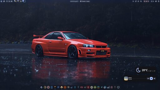 CachyOS + Niri and Noctalia, showing blue, cool colors, custom noctalia bar at the top and a dock at the bottom showing namida (music player) active. The wallpaper is a video of a red R34 in a rainy environment.