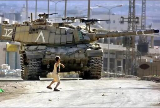 old image of 11 years old Palestinian child Faris Odeh, throwing a rock at an Israeli tank. 

IDF chased him and shot him to death a few days after the picture was taken